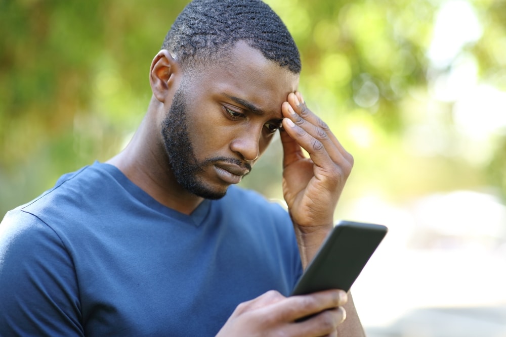 Concerned man checks political news on his phone