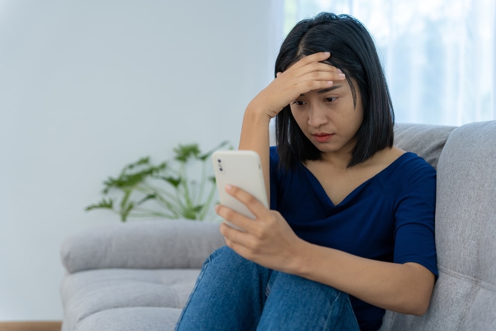 Stressed woman on the phone and in need of digital detoxing