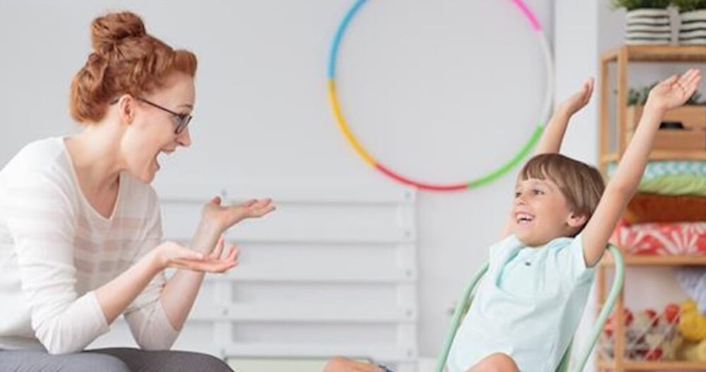 Mom and her child sitting smiling at each other