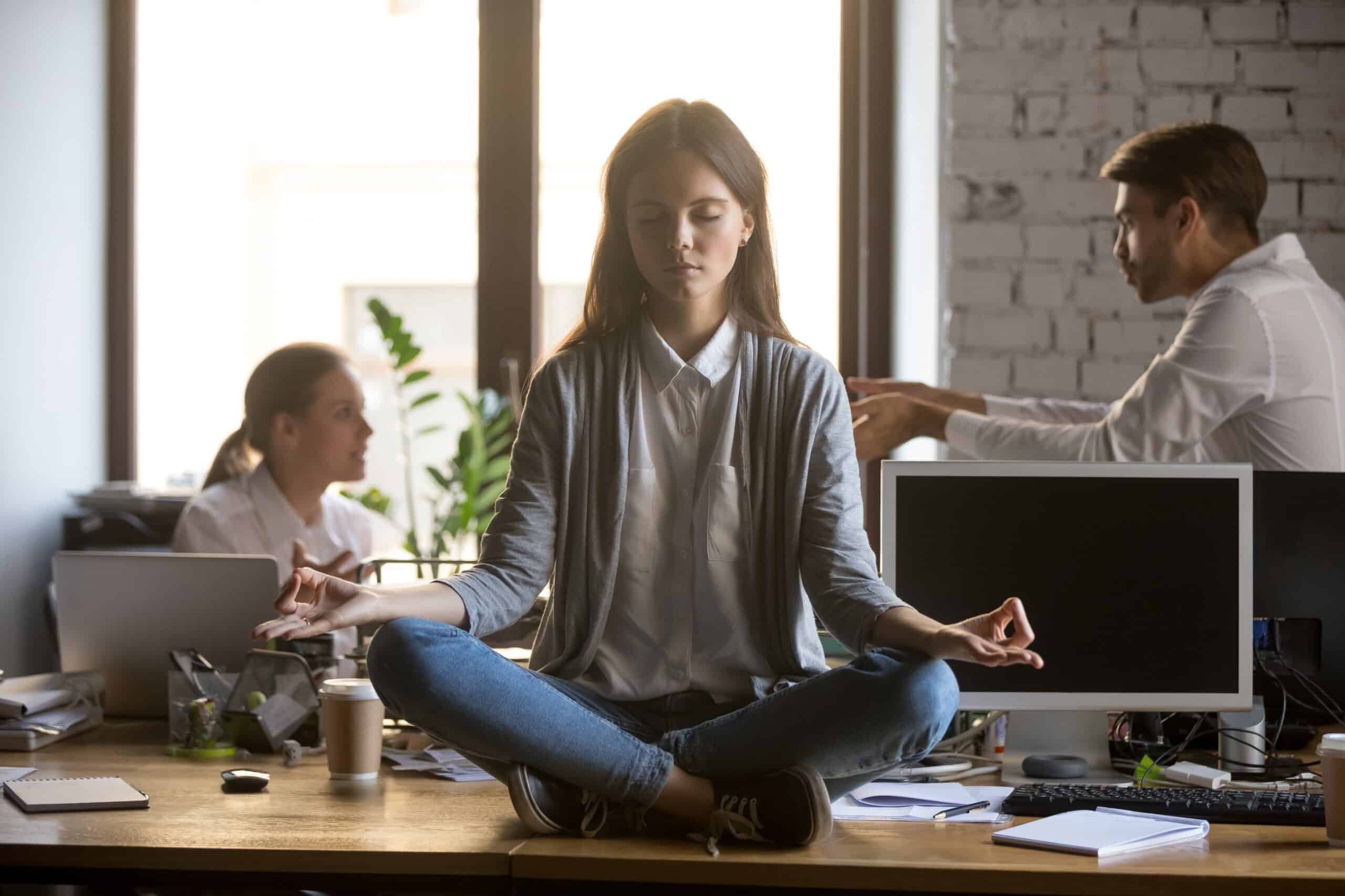 a woman sitting on a table meditating