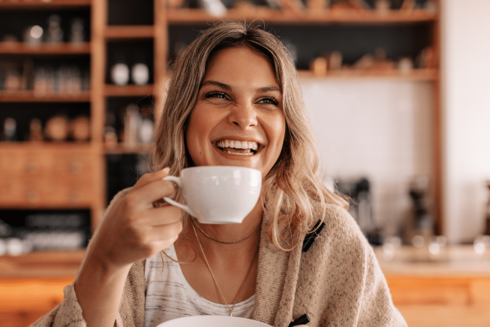 Portrait of a young woman sitting in a coffee shop drinking coffee