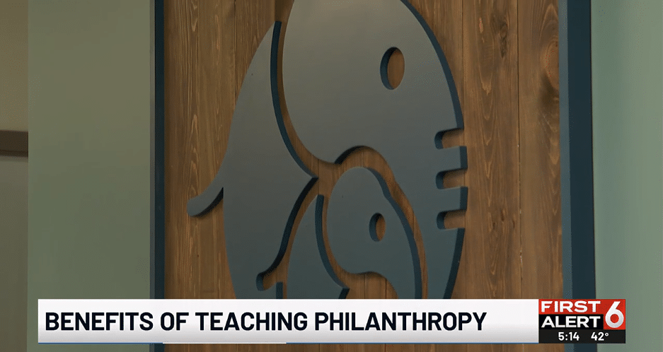 Wooden sign with the Ellie Mental Health logo at the Omaha, NE Clinic